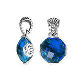 Handmade sterling silver pendant with faceted Blue Topaz Quartz and floral Balinese detailing, artisan crafted in Bali.